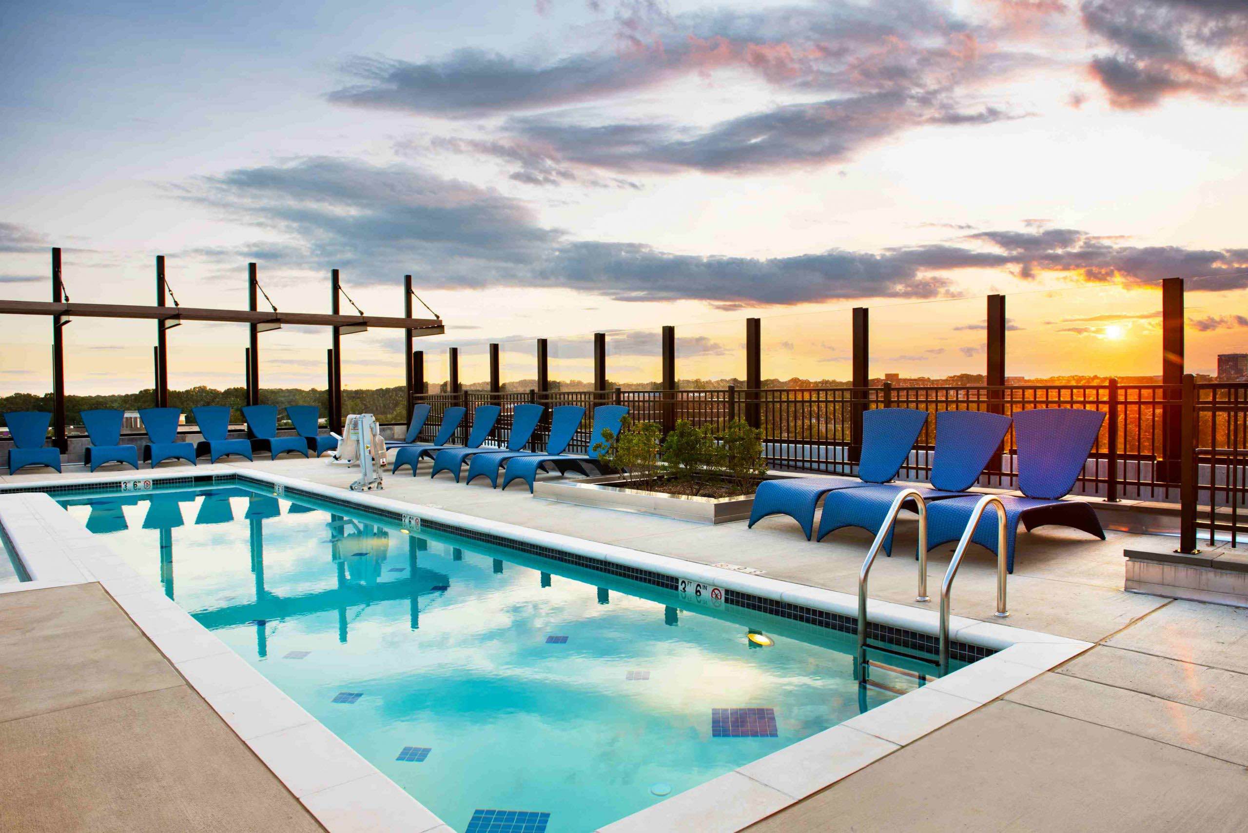 Faraday Park rooftop pool surrounded by lounge chairs